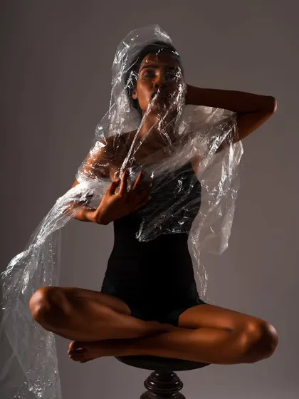 An artistic image from my conceptual portrait series, "UNRAVEL". I use props like this plastic wrap and focused lighting to explore themes and create fine art photographs that are both visually compelling and thought-provoking.
