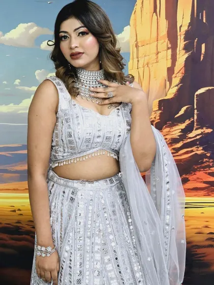 This silver sequined lehenga is paired with a matching American Diamond choker and bracelet. This is a great example of a monochromatic, modern party look.