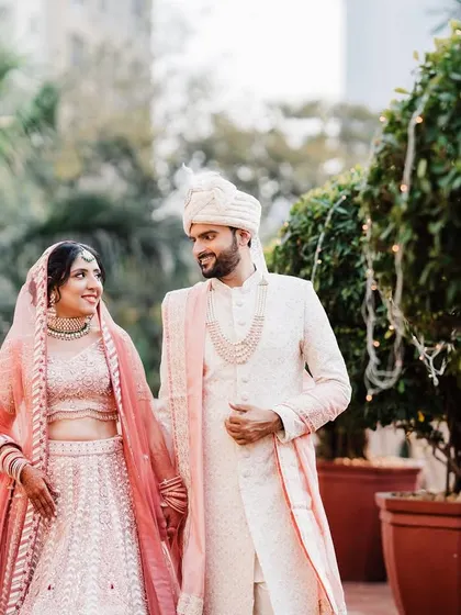 A candid walking shot of the couple, sharing a smile. These unposed moments are often the most genuine and beautiful.