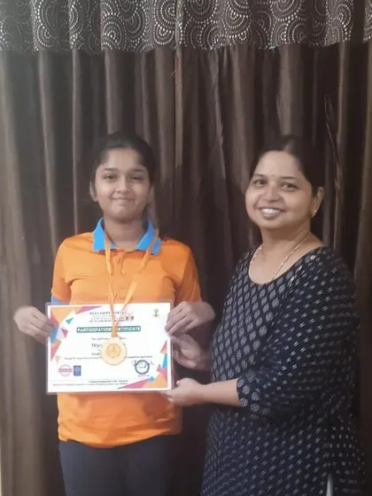 A student from Bellary receives her medal for her outstanding performance. These moments of recognition are incredibly important for building a child's self-esteem and motivation.