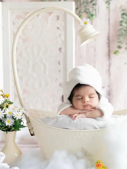 Soaking in the calm. This little one is enjoying a peaceful moment in our miniature bathtub prop, surrounded by daisies.