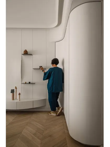 Adjusting the final details in the master bedroom. This shot captures the hands-on, personal approach we take with every project.
