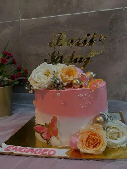 A smaller, single tier version of my popular engagement cake designs, perfect for more intimate celebrations. This one features a pink and white ombre effect, butterflies, and fresh roses.