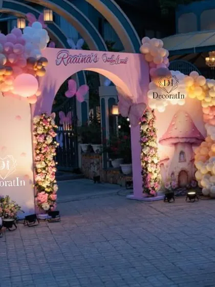 A duplicate of ID 1, showing the grand butterfly-themed entrance arch at dusk, with all the lights creating a magical glow.