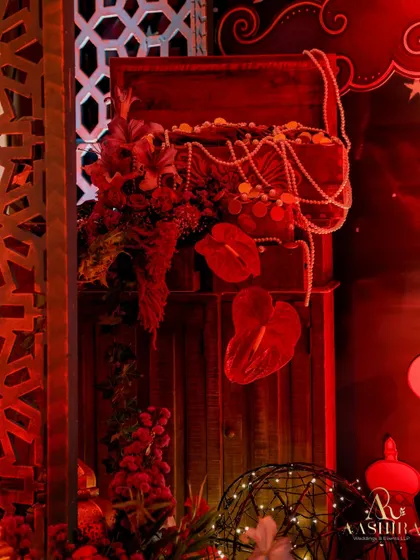 A close-up of a treasure chest, overflowing with faux gold coins and pearl strings, adding to the Arabian Nights theme.