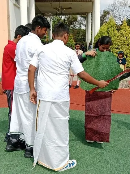 A skit in progress during the assembly, where students use creative costumes to represent elements of nature and convey a message of conservation.