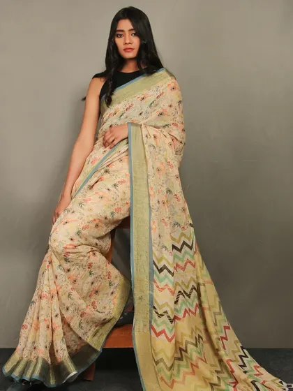 This elegant shot features a model seated in a beautiful printed saree. The pose is designed to showcase the drape and pattern of the fabric, making it an ideal image for a saree brand's catalogue or campaign.