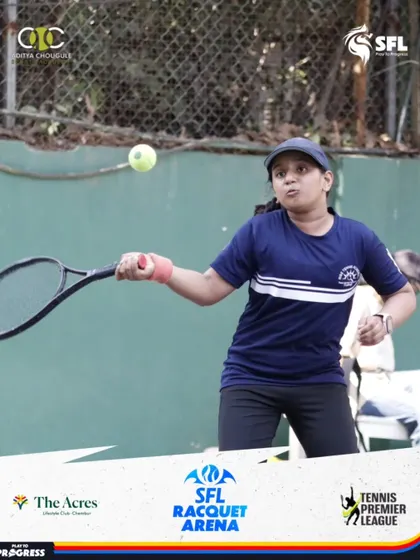A young female player executes a powerful forehand during a match. We are committed to developing strong female athletes and providing a supportive training environment.