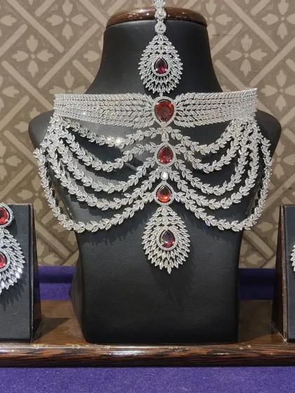A modern, multi-layered choker necklace made with American diamonds and ruby-red stones. A perfect statement piece.