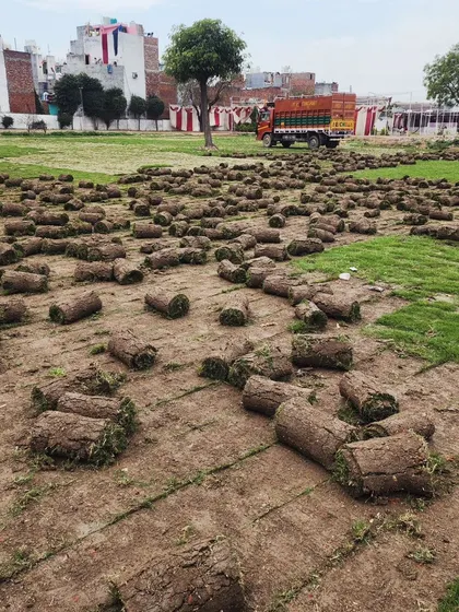 A wide view of a field being prepared with our turf, with a truck and event tent in the background.
