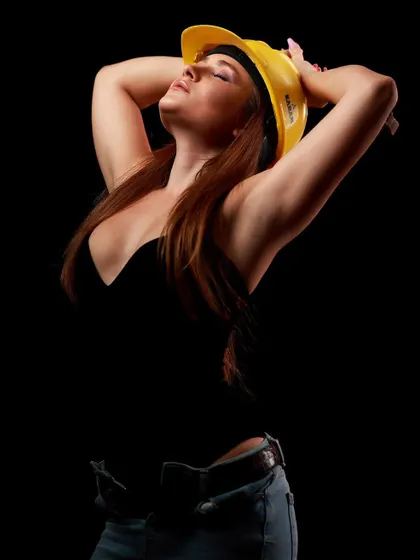 A creative take on a "work" theme, with the model posing in a hard hat. This type of playful, conceptual shoot is great for adding a unique twist to a portfolio.