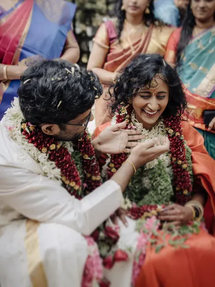 A candid moment of pure laughter during the Thali tying ceremony. This image perfectly encapsulates the joy and emotion of a South Indian wedding.