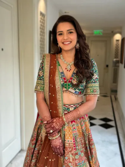 Tripti's Mehendi look was so vibrant and joyful. The makeup was kept fresh and radiant to complement her colorful Mayyur Girotra lehenga, perfect for a day of celebration.