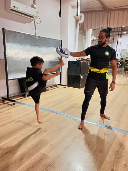 Flying high. This young student shows incredible form and height in his kick, a result of consistent practice and dedication.