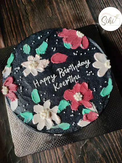 I love when simple bento cake designs translate to bigger cakes. This black cake with painted buttercream flowers has a beautiful, moody, and artistic feel.