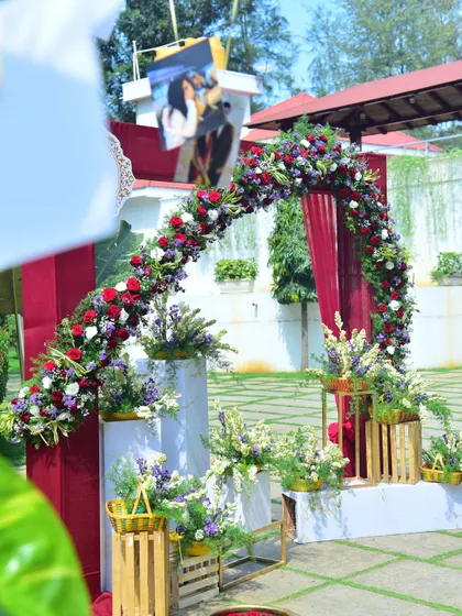 Another look at the beautiful floral photo arch at a sunny outdoor wedding.