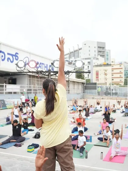 Leading the group in a seated stretch during our International Yoga Day session.