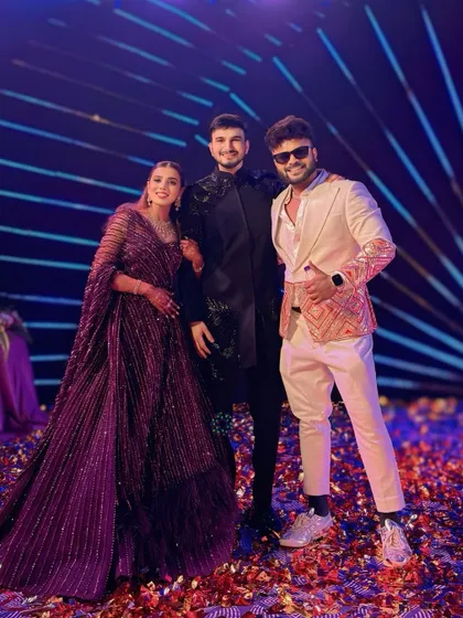 Posing with the happy couple after a fantastic Sangeet night. My custom-designed outfits always make a statement.