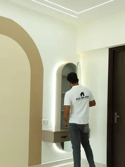 A compact dressing unit with a backlit arched mirror. This space-saving design provides a dedicated spot for getting ready without requiring a large piece of furniture.