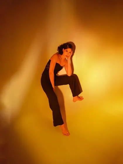 An experimental shot using colored gels to paint the background with a warm, golden-yellow light. The high-angle and distorted perspective create an abstract, artistic feel.