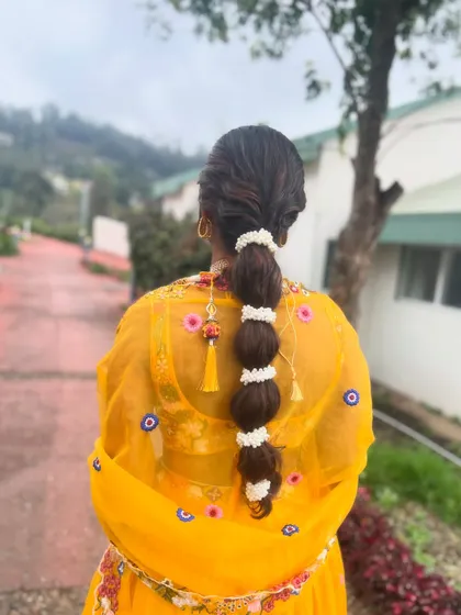 A view of the bubble braid from the back, showing the neat sections and the placement of the jasmine flowers.