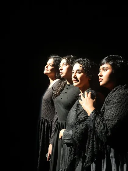 The simmering tension within "The House of Bernarda Alba." This powerful shot captures the all-women cast in a moment of quiet defiance, showcasing the dramatic lighting and ensemble acting that define our productions.