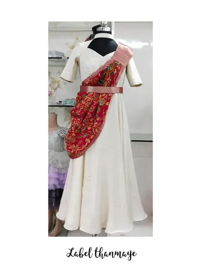 This is an Indo-Western gown I created from a saree. The pallu is draped and held in place with a belt for a modern silhouette.