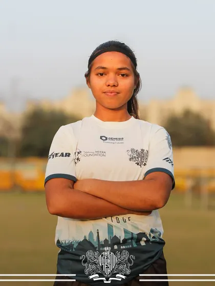 With arms crossed and a focused gaze, this player embodies the strength and resilience of our Lionesses.