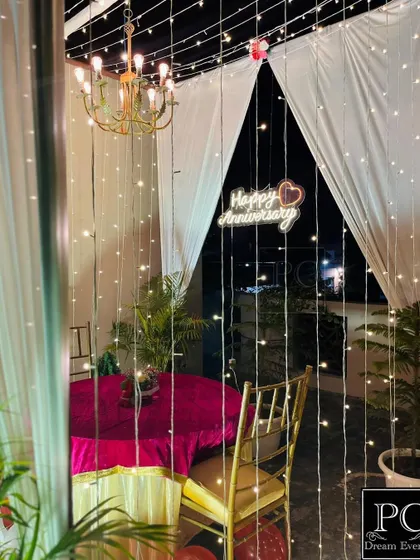 The romantic terrace cabana at night, illuminated by a chandelier and cascading fairy lights. This setup creates a magical and intimate atmosphere for a private celebration under the stars.
