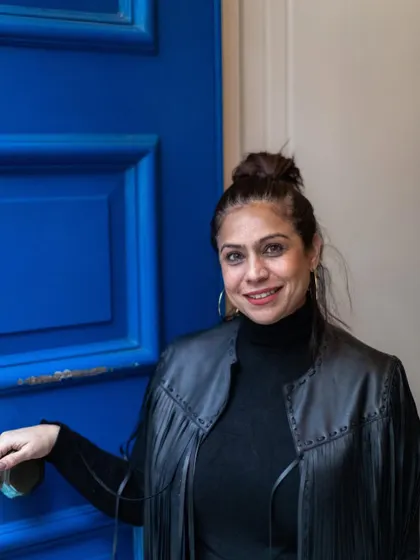 Me by a bright blue door. I'm always drawn to color and character, in spaces and in life.