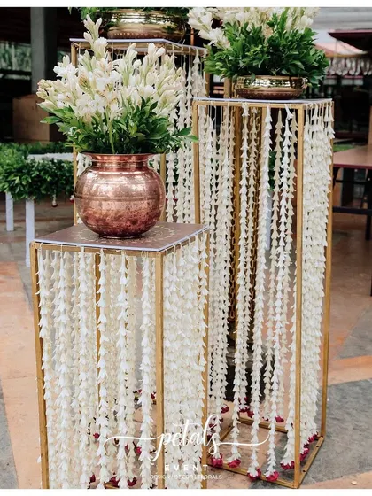 An elegant floral arrangement in a copper pot, part of a beautiful entrance decor.