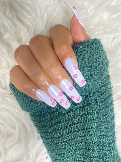 A dreamy Valentine's set with long, square nails. The iridescent white base is decorated with delicate, hand-painted pink hearts for a soft and lovely look.