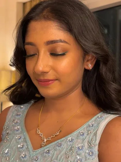A close-up of the eye makeup, showing a simple bronze wash of color and a hint of liner. This is a perfect example of an understated yet elegant look.
