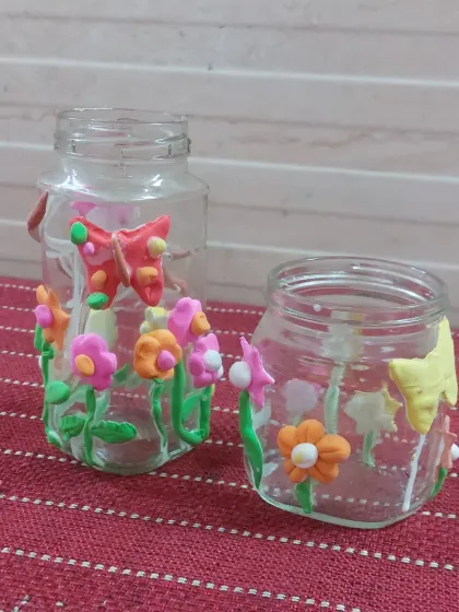 A close-up of the clay-decorated jars from our Spring workshop. This activity combines recycling with creativity.