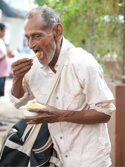 An elderly man enjoys a warm, nourishing meal. Our mission is to create a kinder, healthier world by fighting hunger.