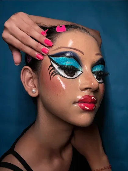 This pose showcases the full face, including the drawn-on eyebrows and exaggerated features that define this unique pop art look.