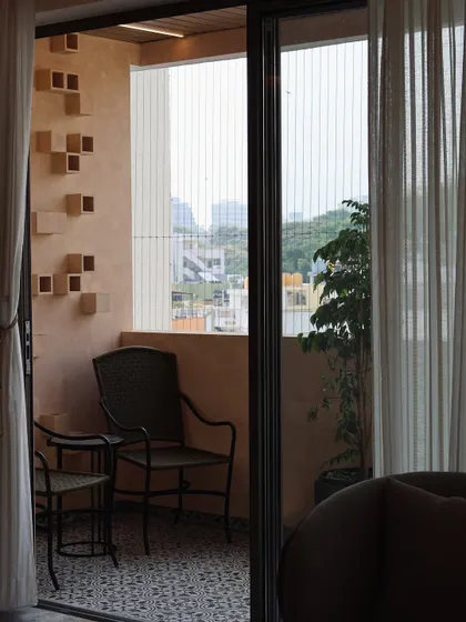 This view shows how the balcony connects to the interior living space. The design provides a seamless transition from inside to outside, extending the living area and bringing in natural light.