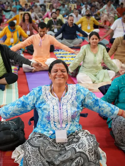 The goal of our practices is a joy that bubbles up from within. This participant's smile during a session on the Patanjali Yoga Sutras captures the happiness and sense of release that comes from connecting with deep wisdom and meditation.
