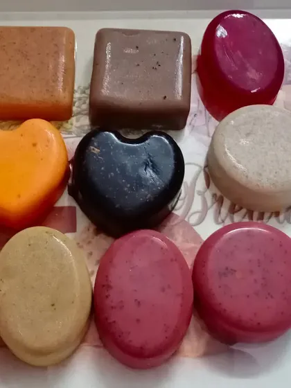 A collection of my trial-sized soaps in various shapes, colors, and formulations. You can see coffee, charcoal, orange, red wine, and ubtan soaps here.