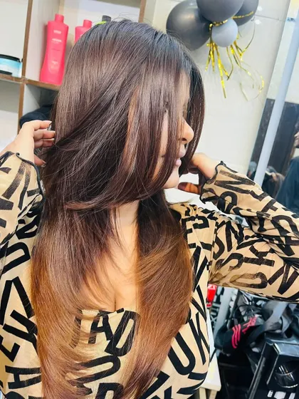 A side view of a beautiful feather cut, showing the soft, face-framing layers.
