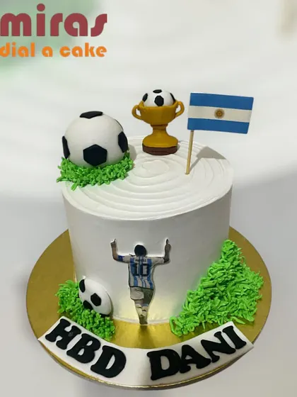 A tribute to a football legend, this cake is perfect for a Messi or Argentina fan. It features an edible image of the player, a trophy, and the Argentinian flag.