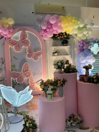 Another angle of the pastel butterfly decor, showing the arrangement of props and shelving.