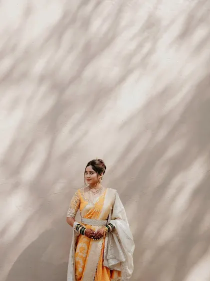 The artistic play of light and shadow highlights the beautiful silhouette of the Nauvari drape.
