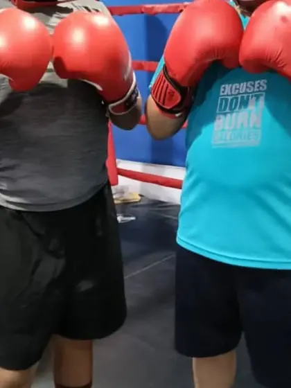 Our young champions are always preparing for the next challenge. Here, two of our junior members pose in the ring, ready for their training session focused on cardio, conditioning, and competition prep.