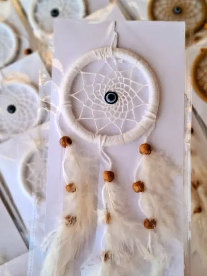The white version of the mini dreamcatcher, with an evil eye bead woven into the center.