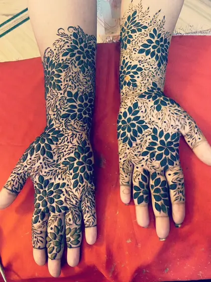 A bold and beautiful statement. This design uses negative space to make the floral patterns stand out, creating a unique and modern look that covers the hands and arms.