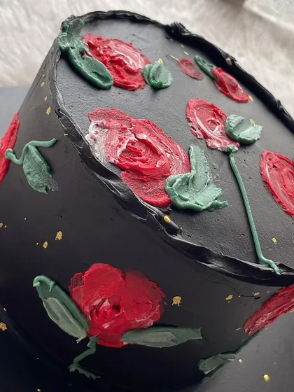 A bold and beautiful black ganache cake with hand-painted red roses. This design is dramatic, romantic, and perfect for someone who loves a bit of gothic elegance.