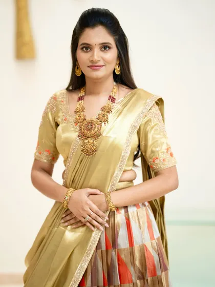 A close-up of the client, highlighting the delicate embroidery on her golden blouse.