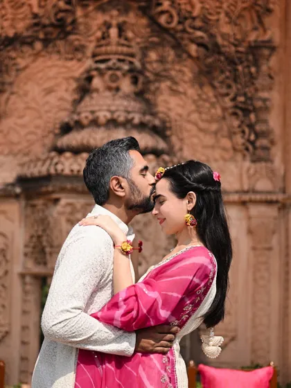 An intimate moment between the couple at their 'Gulnar' Mehendi, set at an ancestral home in Delhi. The historic, carved stone wall provided a stunning, meaningful backdrop.