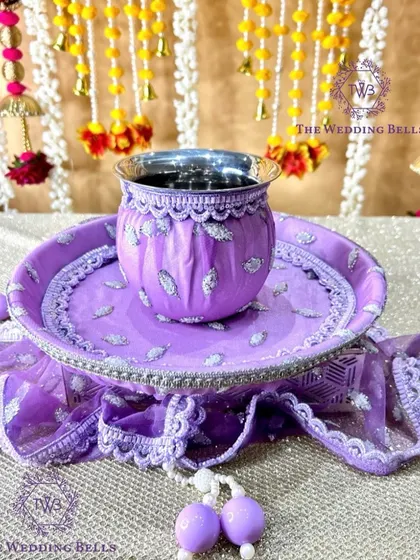 The base of our lavender thali set, showing the intricate fabric work and matching thaal cover.